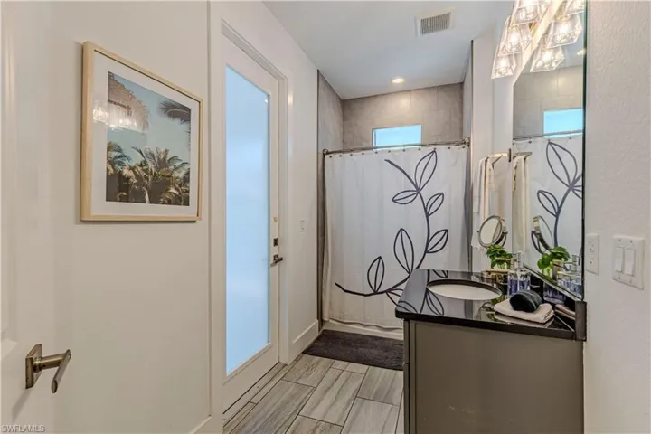 Bathroom with vanity and a shower with shower curtain