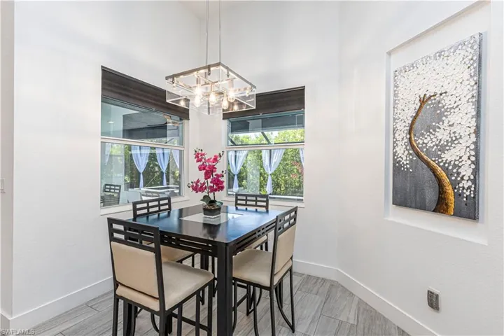 Dining area featuring baseboards and a chandelier