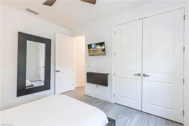 Bedroom with a closet, a ceiling fan, and baseboards