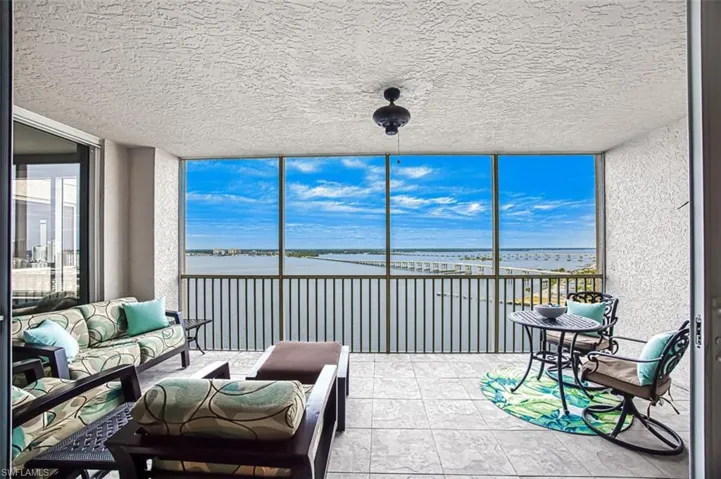 Sunroom / solarium with a water view