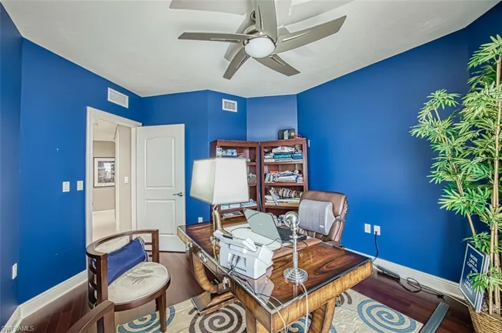 Office space with ceiling fan and hardwood / wood-style flooring
