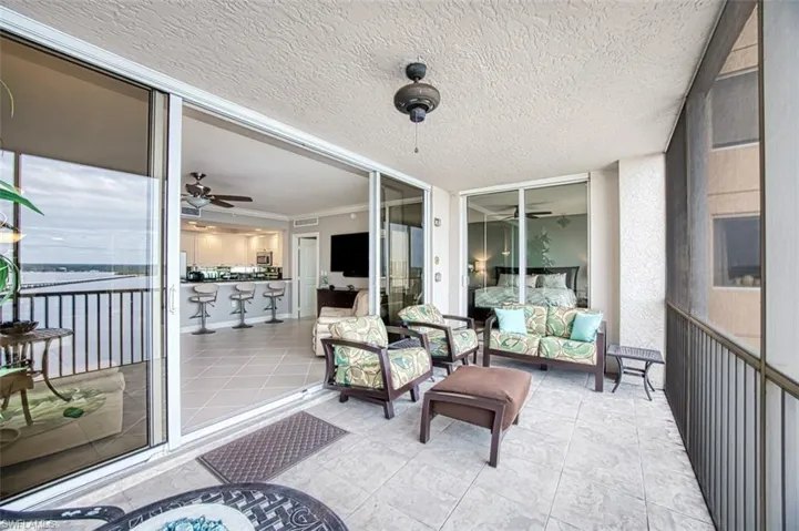 Sunroom / solarium featuring ceiling fan