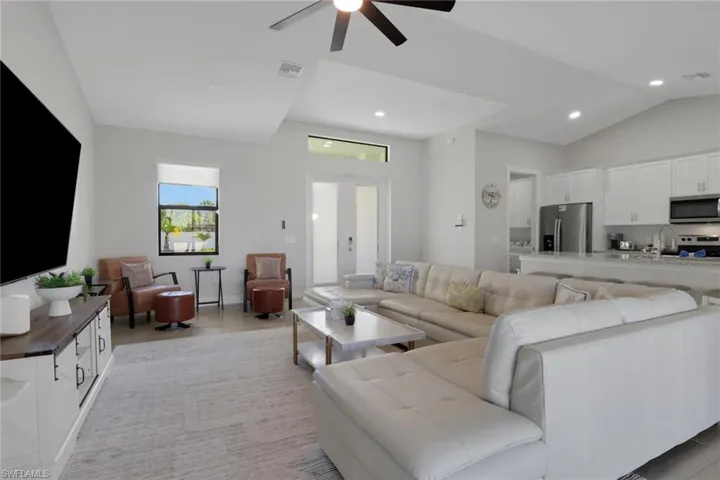 Living area featuring french doors, ceiling fan, and recessed lighting
