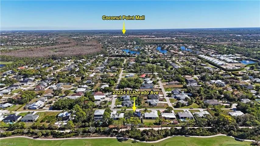 View of property location featuring nearby suburban area, a golf club, and a nearby body of water