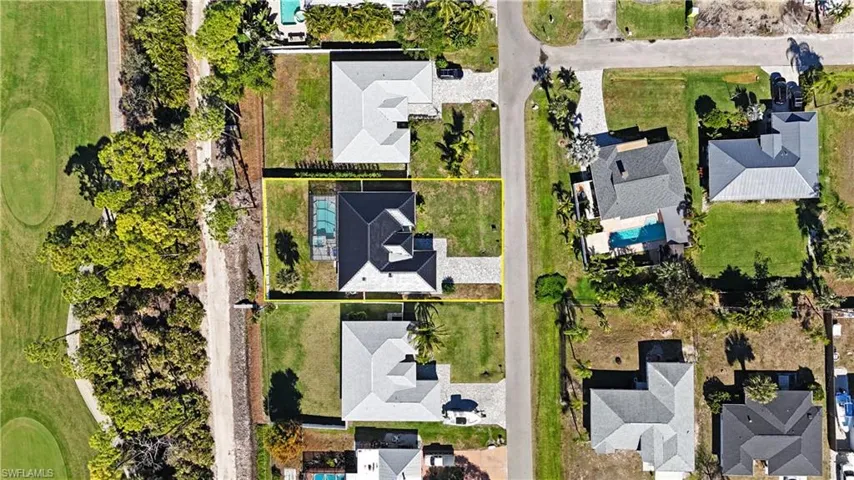 Aerial perspective of suburban area with a golf course and property boundaries highlighted