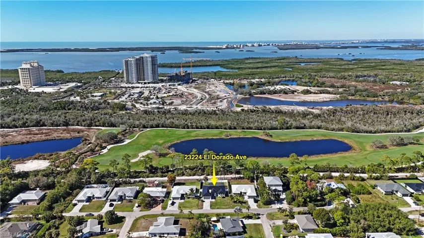 View of property location with a nearby body of water and a local golf course