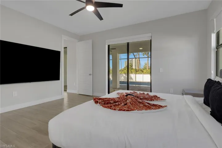 Bedroom with ceiling fan, access to outside, and light wood-type flooring