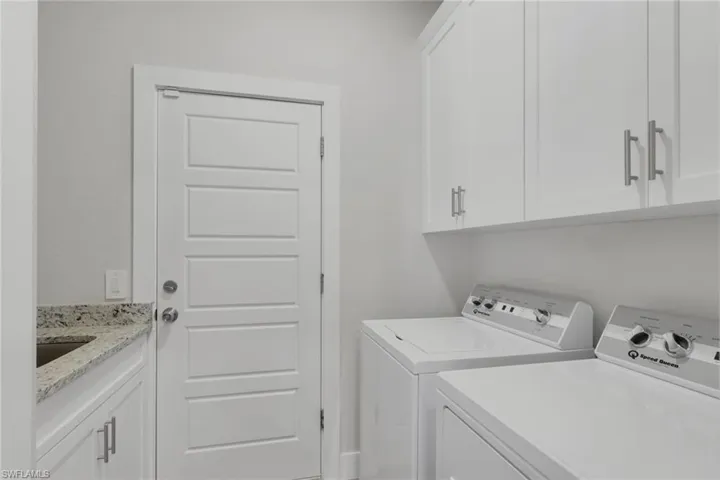 Laundry area featuring washer and clothes dryer and cabinet space