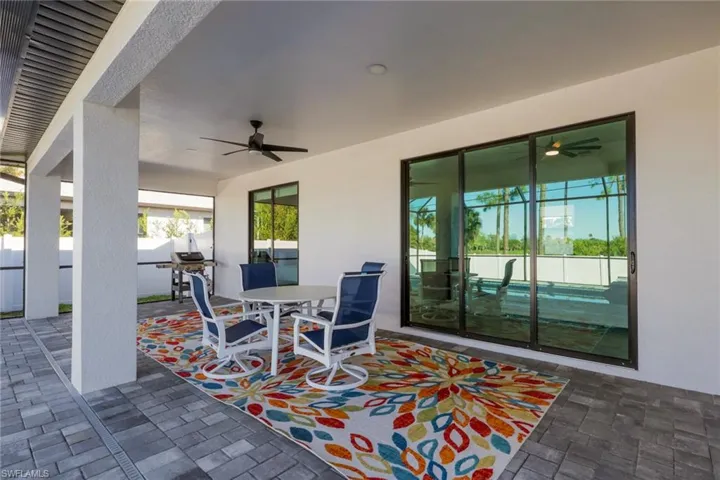 View of patio featuring outdoor dining space and a ceiling fan