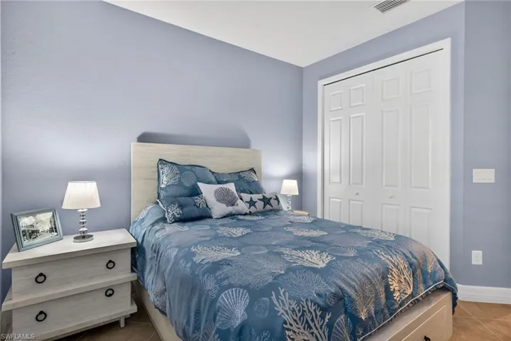 Bedroom featuring a closet and light tile patterned floors