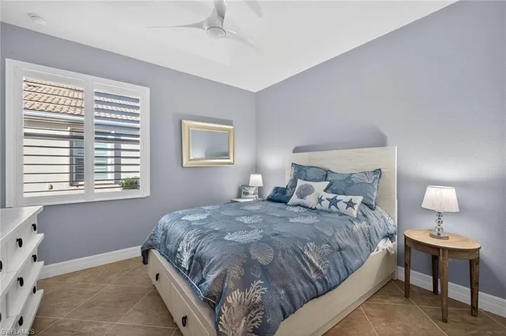 Bedroom with tile patterned flooring and a ceiling fan