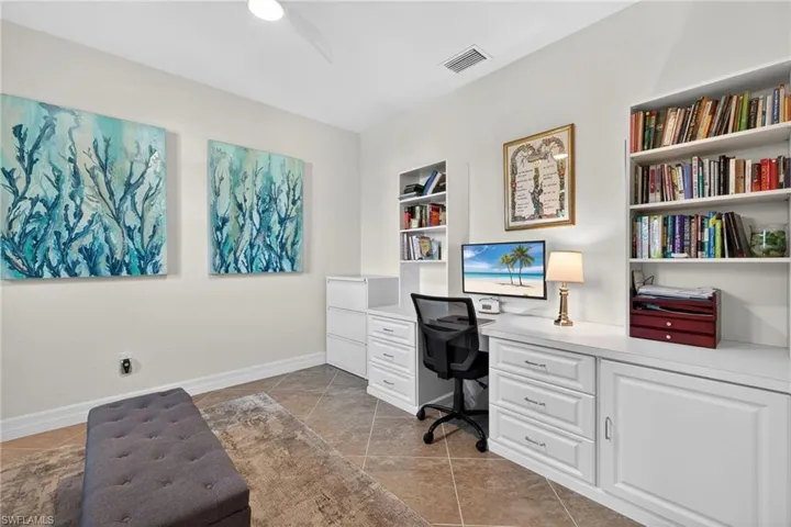 Office featuring built in study area and light tile patterned floors