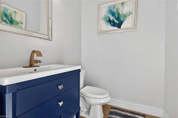 Half bath with vanity and tile patterned floors