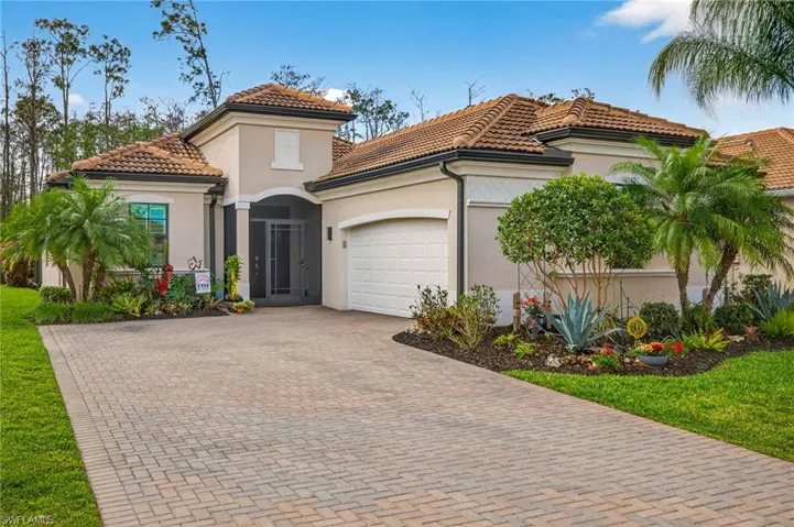 Mediterranean / spanish house featuring a garage, stucco siding, decorative driveway, and a tile roof