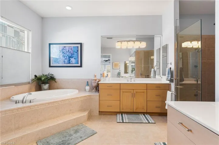 Primary batheroom has a large soaking tub and a walk in shower.