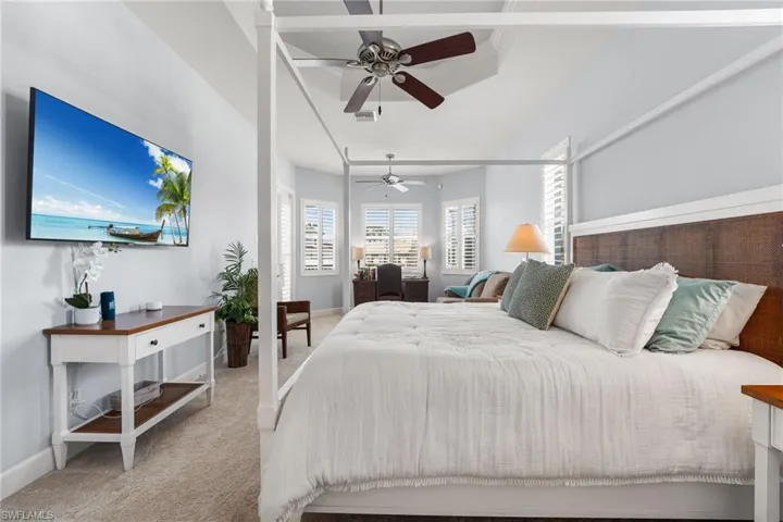 Carpeted bedroom featuring ceiling fan