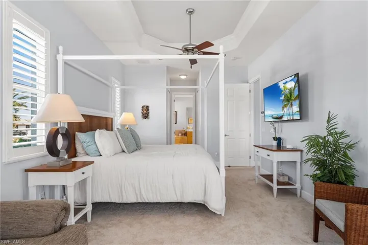 Bedroom featuring light carpet, ornamental molding.