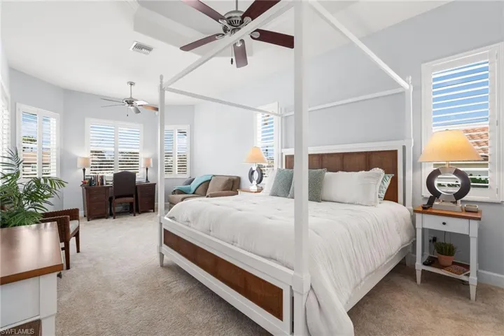 Your primary suite has a large seating area with views of the pool and canal.