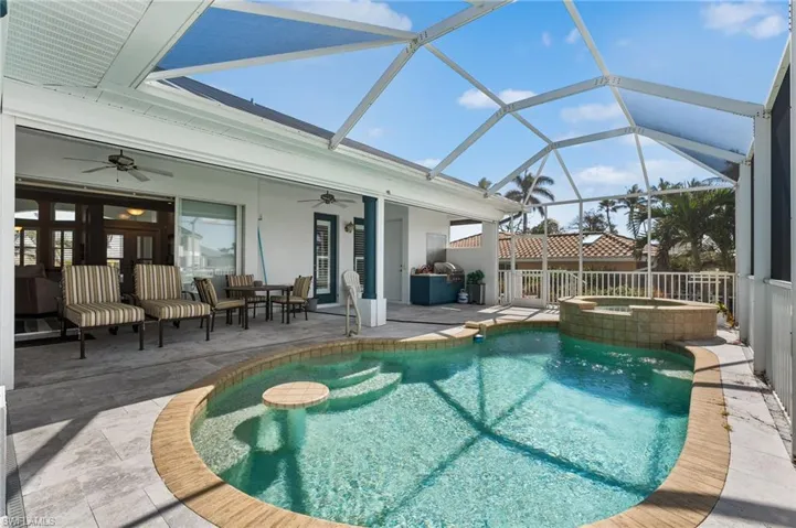 Outdoor kitchen, hurricane screens for peace of mind. Swim up table