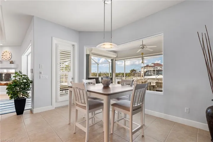 Dining space featuring light tile patterned flooring and ceiling fan