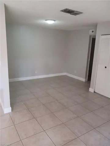 Spare room with light tile patterned floors and a textured ceiling