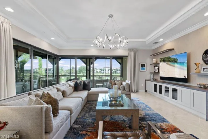 Living area featuring hanging lights and crown molding