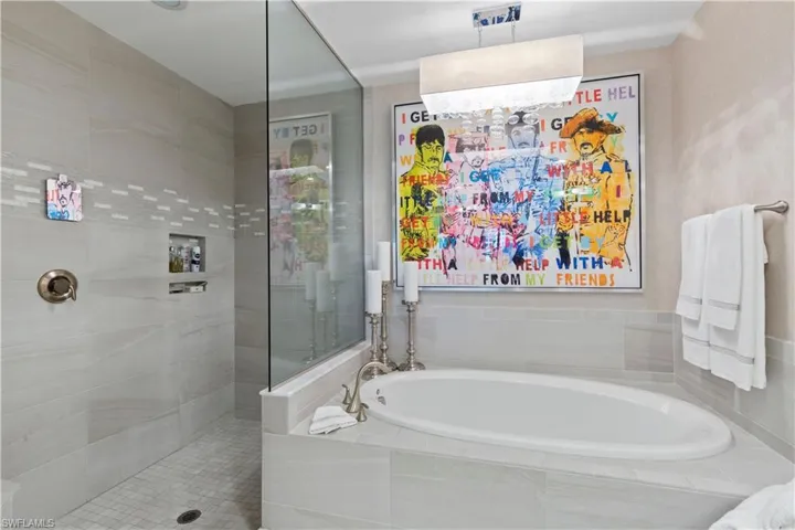Bathroom featuring walk in shower and a garden tub