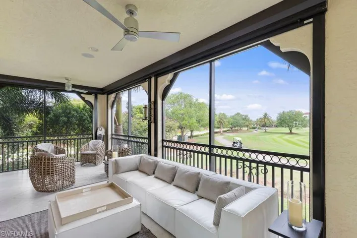 Sunroom featuring view of golf course