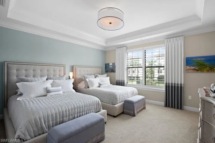 Bedroom featuring carpet floors and crown molding