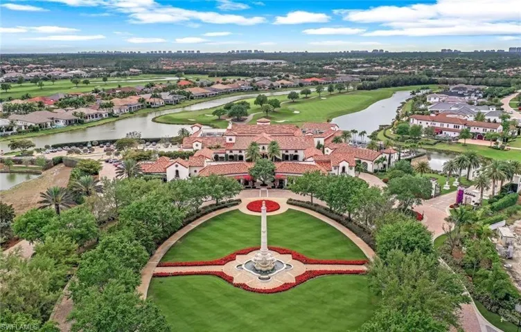 Aerial perspective of suburban area featuring a nearby body of water and a local golf course