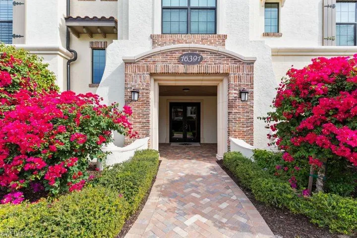 Doorway to property with brick siding and stucco siding