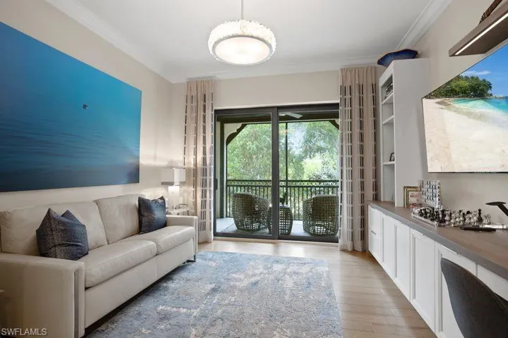Living area featuring crown molding and light wood-type flooring