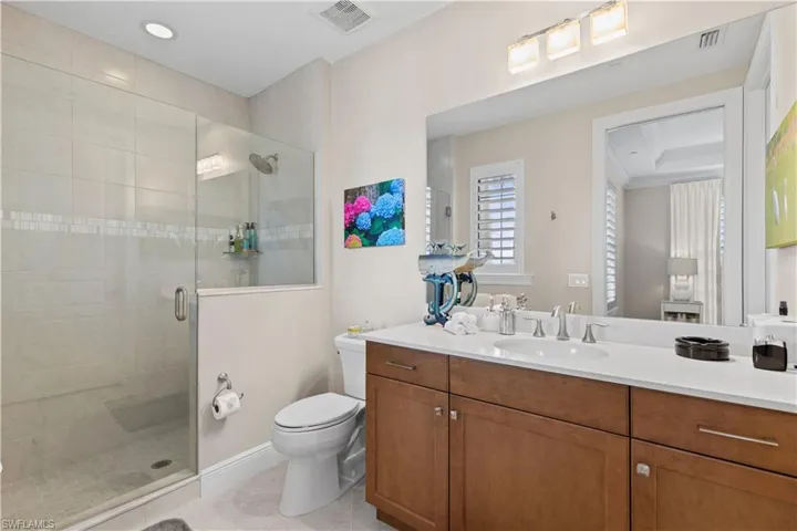 Full bathroom featuring a stall shower and vanity