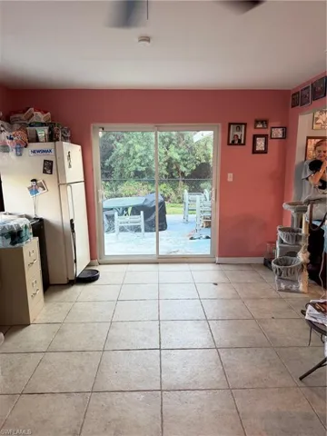 Unfurnished dining area with light tile patterned flooring and baseboards