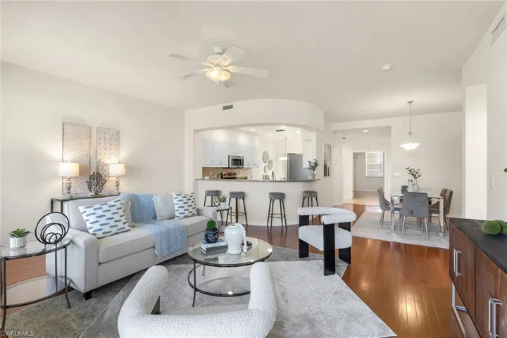 Living room featuring amazing views, wood floors, a wealth of natural light, and ceiling fan