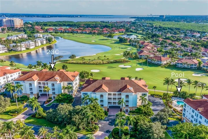 Birds eye view of property with a water view and golf course