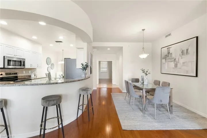 Kitchen counter with stools and dining area