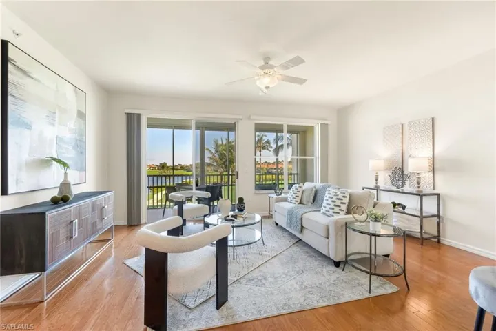 Living room featuring wood flooring amazing views, slider to lanai, and ceiling fan