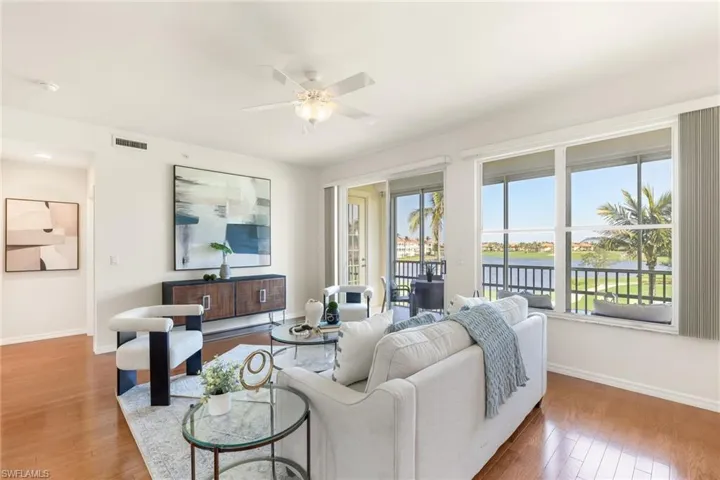 Living room featuring amazing views, wood floors, a wealth of natural light, and ceiling fan