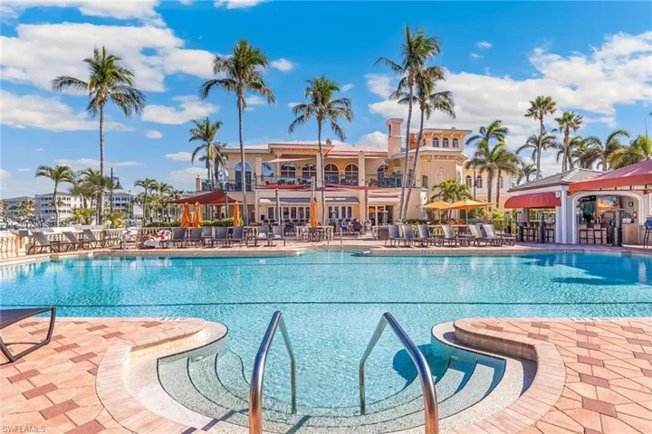 View of community pool and clubhouse at Gulf Harbour
