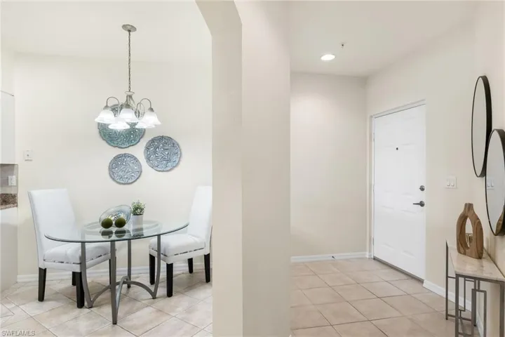 Entry area with tile floors and archway into the kitchen and eat-in area