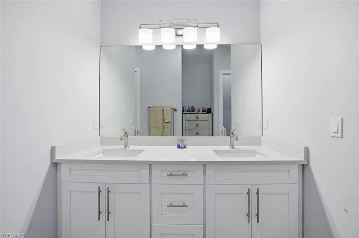 Full bath featuring double vanity