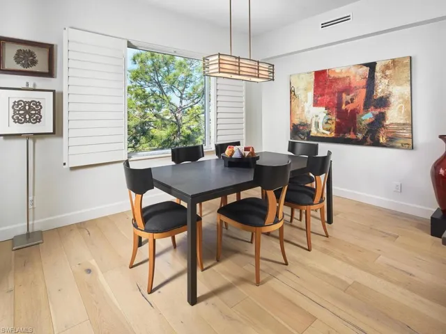 Chic dining space with large windows and elegant details.