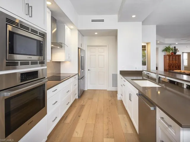 Beautifully appointed kitchen with custom cabinetry, stainless steel appliances, and ample counter space.