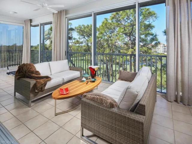 Bright and inviting lanai space with panoramic nature views, perfect for relaxation.