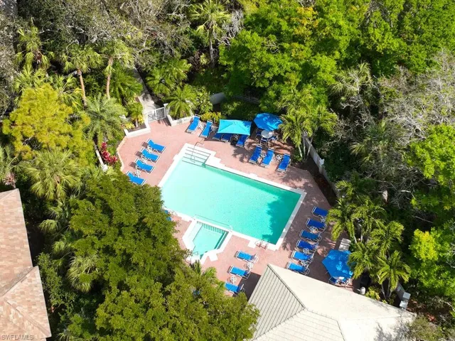 Sparkling resort-style pool surrounded by lush landscaping.