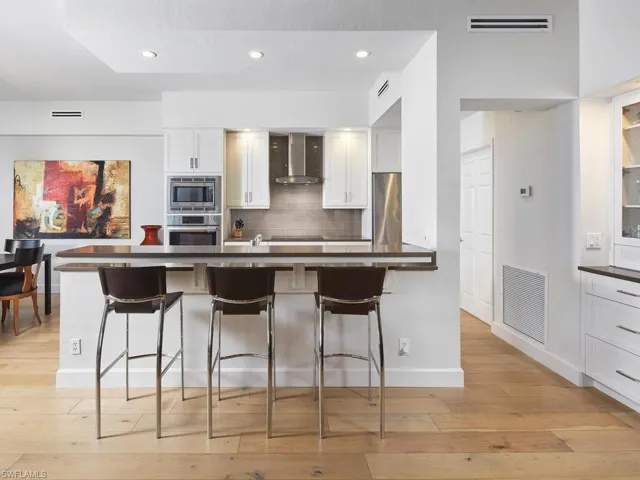 Sleek, updated kitchen with an oversized island and high-end appliances.