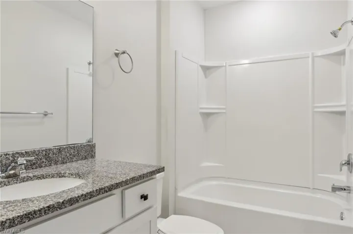 Full bath with toilet, vanity, and shower / bath combination