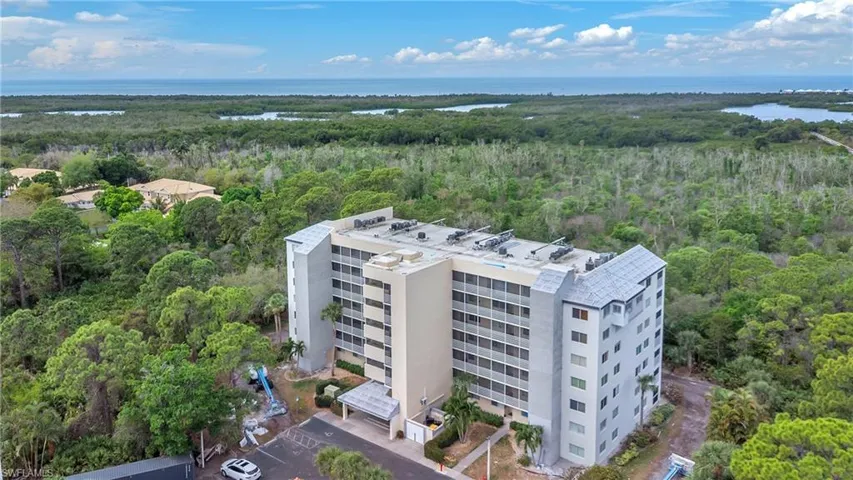 Aerial view of a heavily wooded area and a large body of water