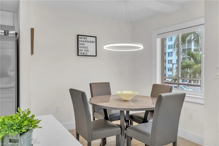 Dining space with baseboards and light wood-type flooring